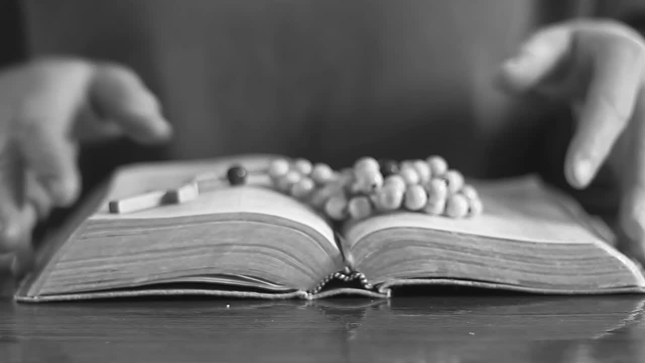 praying to God hands on bible with people stock video stock footage