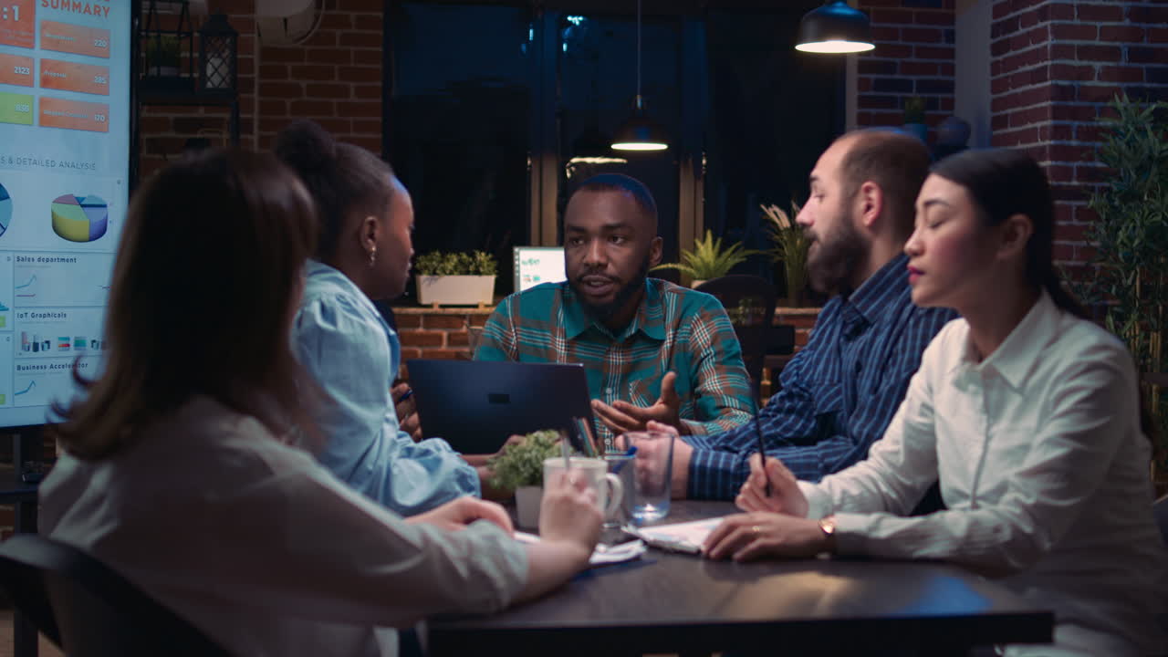 Coworkers brainstorming, employee showing data charts on laptop screen