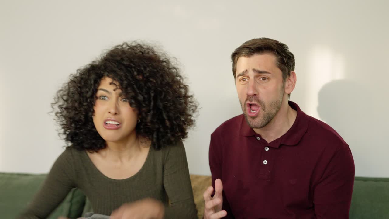 Multiethnic couple celebrating that their football team win a match