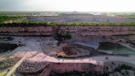 haul truck driving thornton illinois quarry: massive limestone excavation site reveals geological layers and mining operations