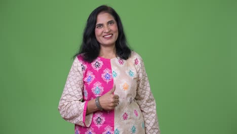 mature beautiful indian woman smiling while giving thumbs up