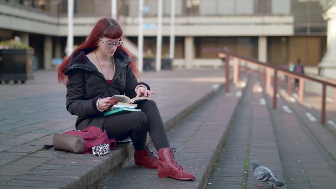 slow otion wide shot of young woman becomin happy as she finds the answet to her question