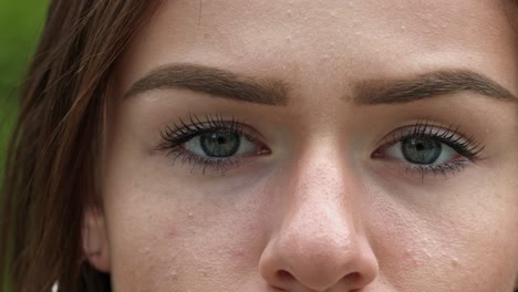 Extreme-close-up-shot-of-a-brunette-model's-green-eyes-blinking-in-slow-motion