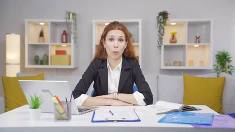 home office worker woman looking at camera confused.