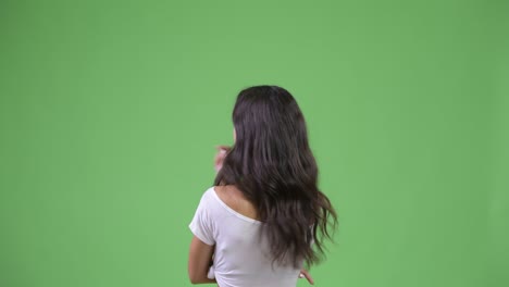 rear view of young multi-ethnic woman pointing finger