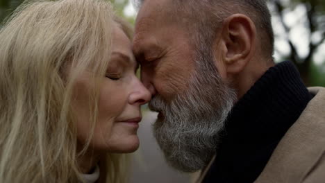 portrait of beautiful romantic senior couple enjoying of each other on street.