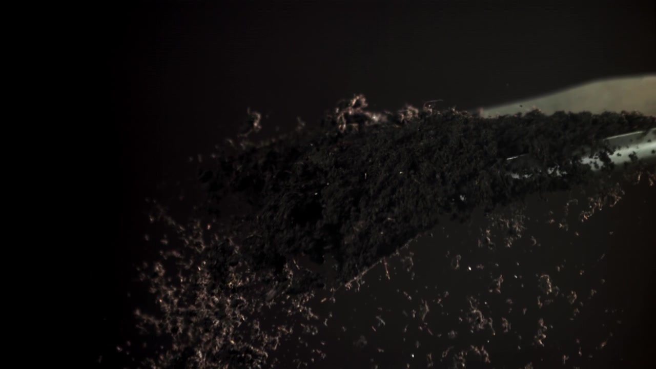 Slow Motion Close Up of Dark Earth Being Scooped by a Shovel