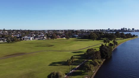 Drone-shot-across-and-South-Perth,-foreshore-Swan-River-to-skyline-of-Perth,-Western-Australia-foreshore