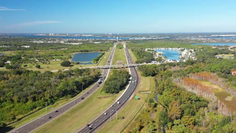 aerial shot of three lane highway and road bridge towards sarasota, florida