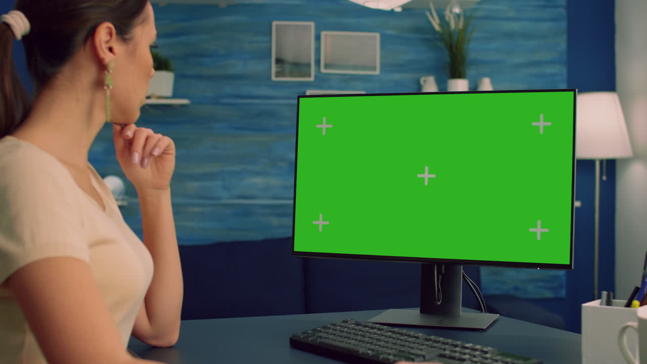 Freelancer woman at home sitting on desk table working on computer
