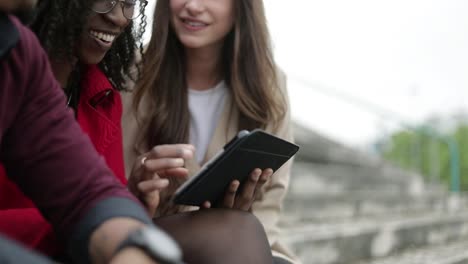 Side-view-of-young-people-googling-on-tablet-place-to-go