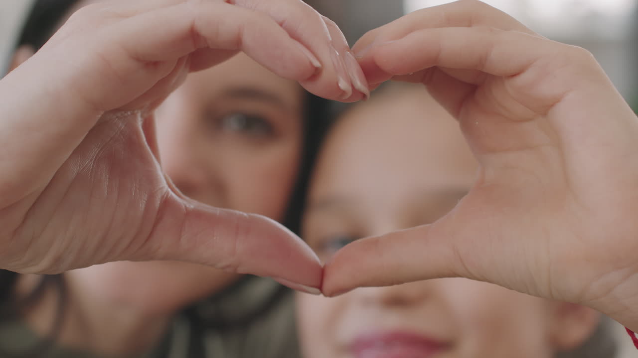 Mother and Child Making Heart Shape with Hands