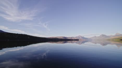 autumn scene looking across lake at colorful sunset at lake mcdonald in montana