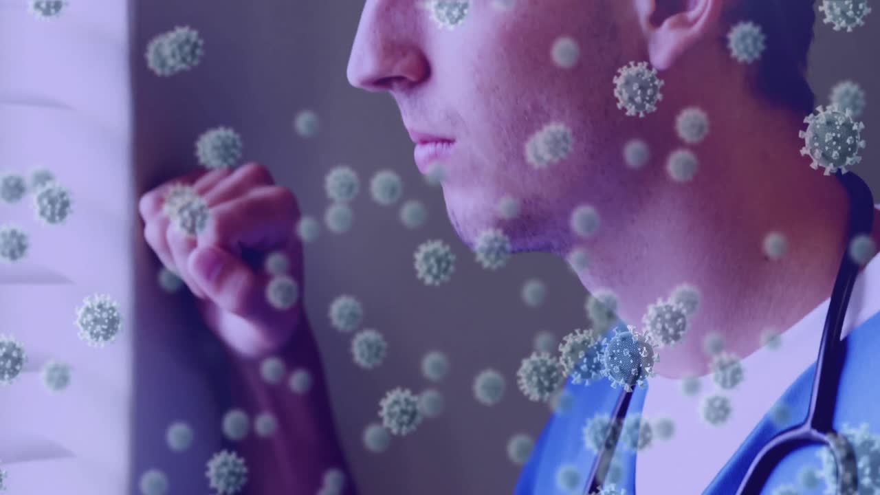 Multiple covid-19 cells moving against male health worker with stethoscope around his neck looking o