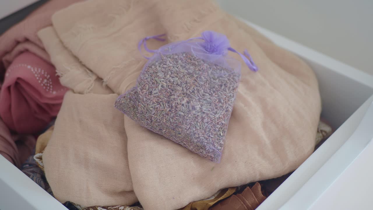Lavender sachets in a drawer with clothes