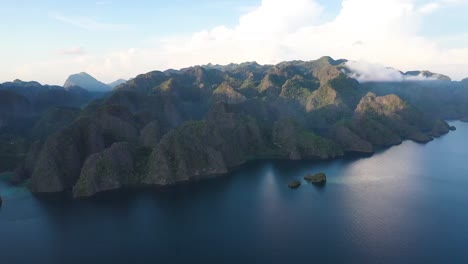 View-from-above,-stunning-aerial-view-of-a-turquoise,-crystal-clear-sea-during-an-amazing-sunrise