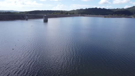 Flying-over-water,--dam-wall-in-the-background