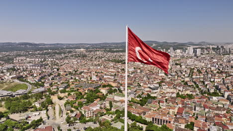 Istanbul-Turkey-Aerial-v78-panoramic-view,-drone-flyover-camlica-hill,-fly-around-massive-wavy-turkish-flag-capturing-downtown-cityscape-and-bosphorus-strait---Shot-with-Mavic-3-Cine---July-2022