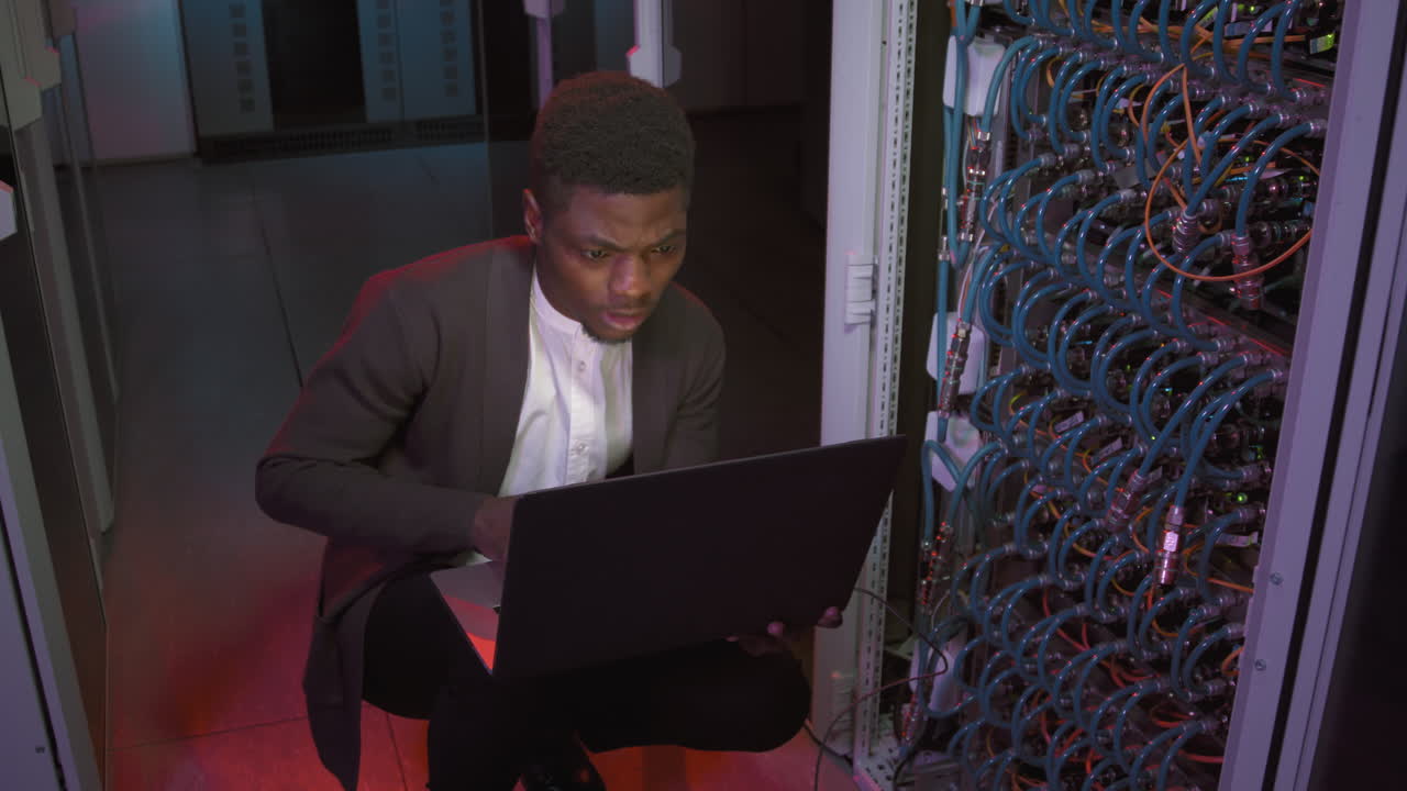 Black Male Network Engineer Working in Data Center