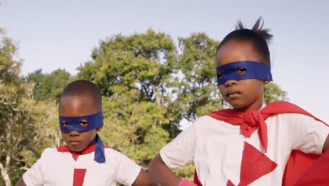 family posing in costume of superheroes