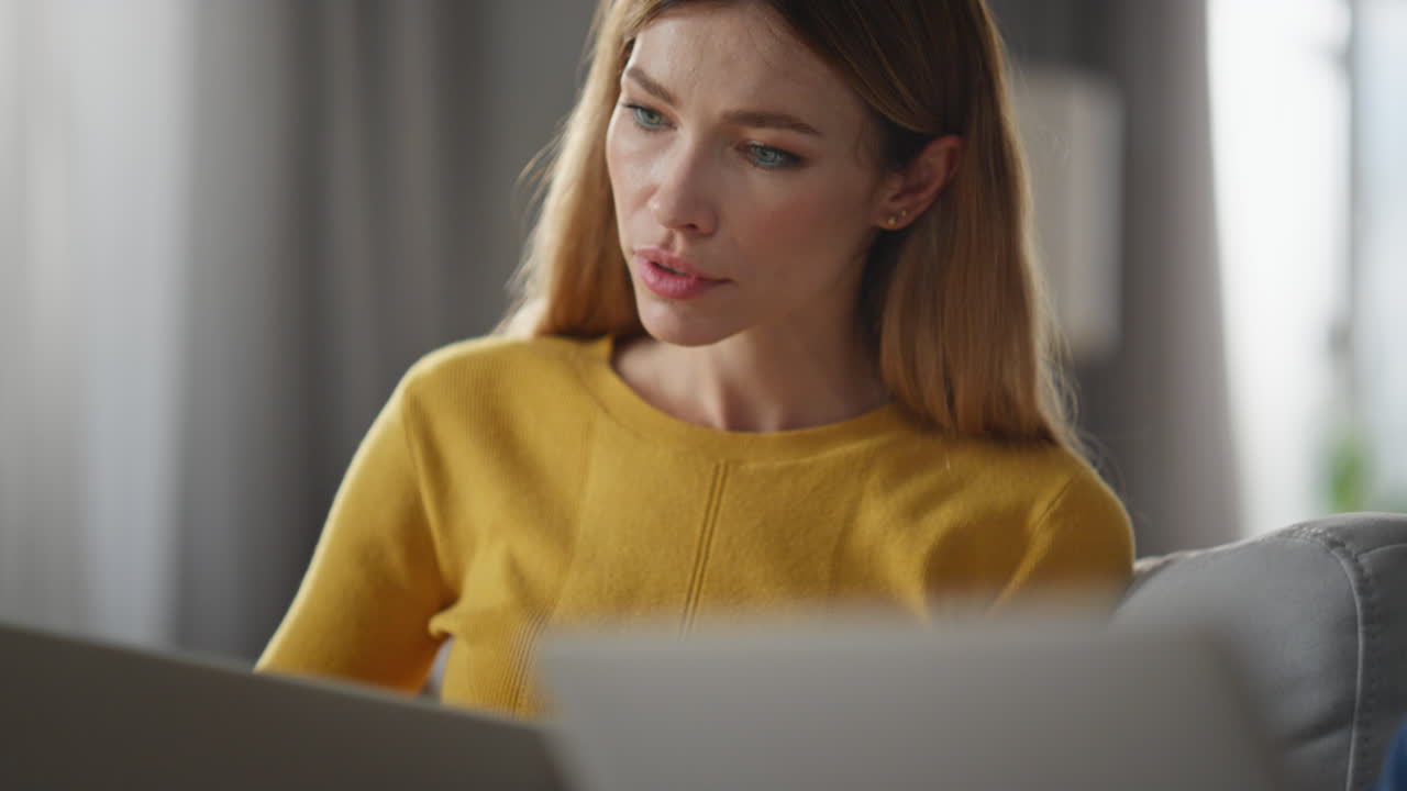 Closeup man hands typing keyboard holding laptop on knees. Woman asking husband
