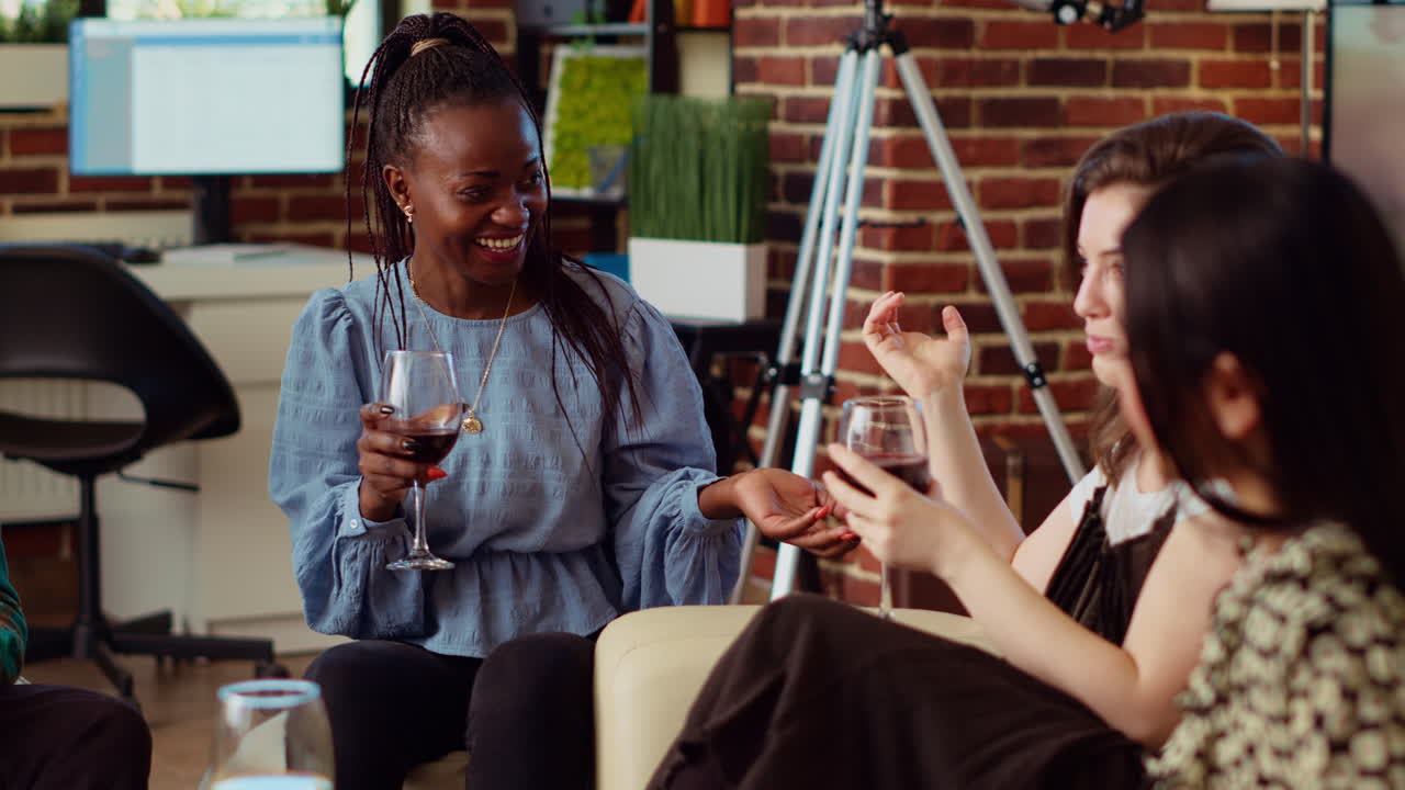 Multiethnic BFFs catching up with each other at home, drinking alcohol
