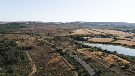 Rising-drone-footage-over-heathland-and-water