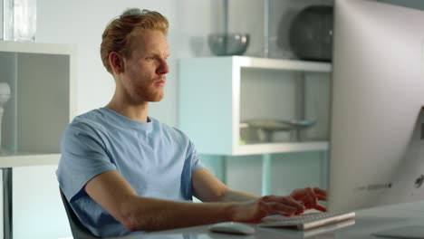 Student-working-studying-home-closeup.-Confident-ginger-man-writing-check-email.