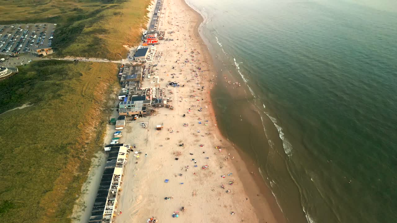 Wide Slow Motion Drone Flight Rising Over Grass Landscape And Road Next To Beach And Coastline Of Castricum, the Netherlands