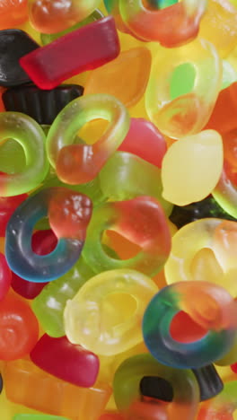 video of multicoloured candy jelly on yellow background