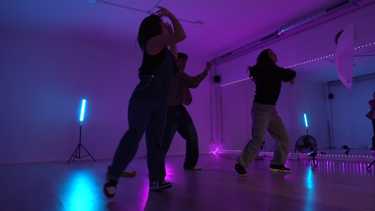 Dance performance in neon lit studio