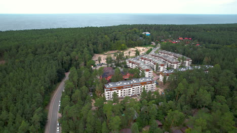 aerial - complex of residential buildings situated in the middle of a forest among trees in the town of stegna - a short distance from the gdańsk bay coastline - a popular tourist city in poland