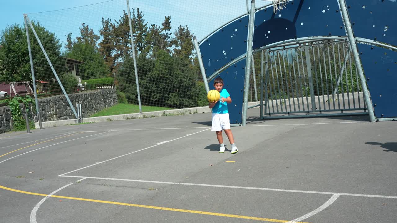 Boy Dribbling Basketball on Outdoor Court with Woman Watching