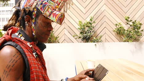 tribal man using digital tablet 4k