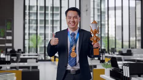 businessman celebrating success with a trophy