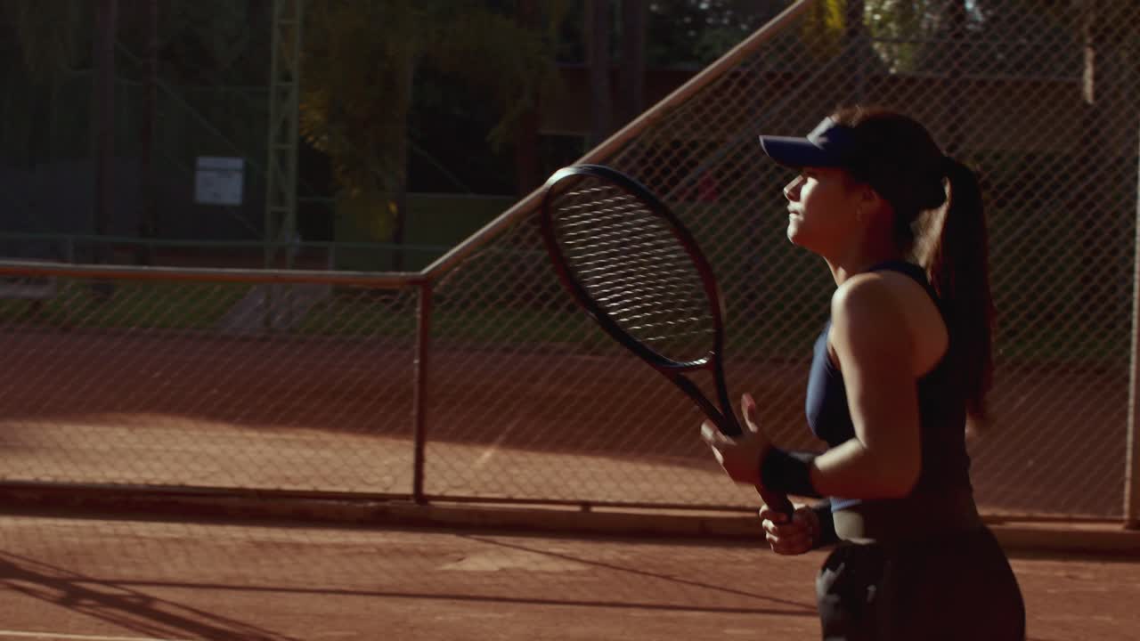 A female tennis player on a clay court with a racket