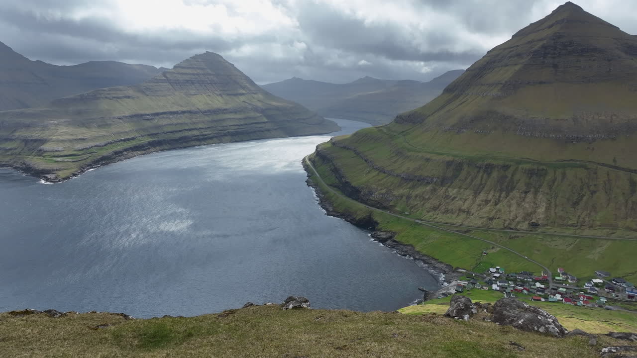 Panoramic aerial view of a village along a stunning fjord in the Faroe Islands, Denmark