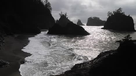 waves crash on the oregon coastline on an overcast day