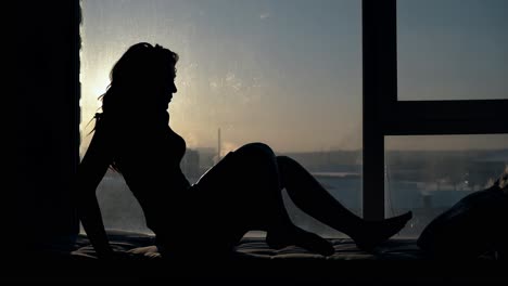 mujer elegante se siente cómoda en el lugar de descanso cerca de la ventana
