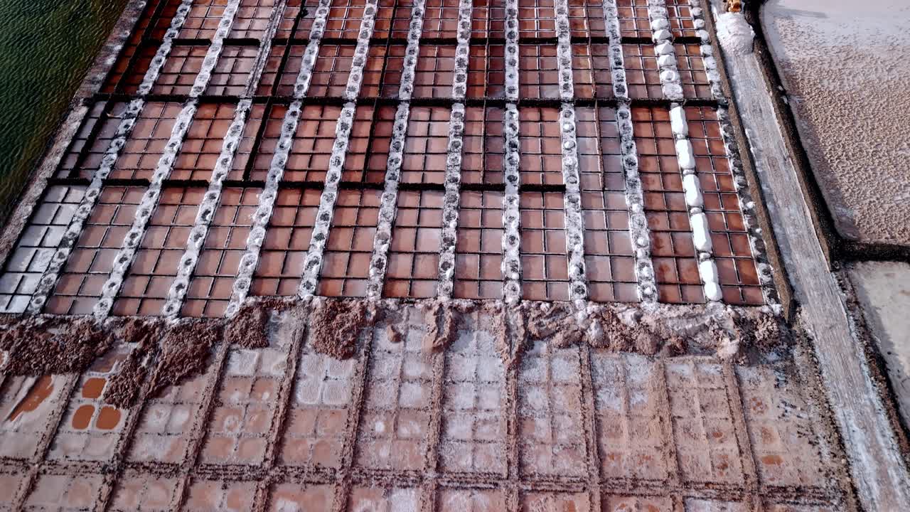 Beautiful aerial drone footage of the Salinas de Janubio salt flats at sunset in Lanzarote, Canary Islands, Spain.