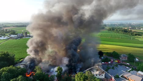 thick smoke fills the sky as fire rages from exploded building