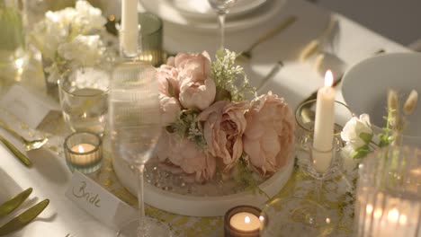 close up of bouquet on table set for meal at wedding reception with place card for bride