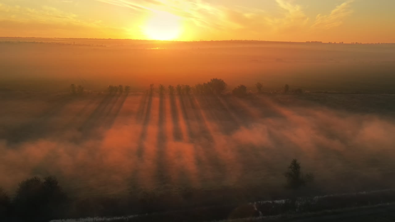 Aerial drone view of nature in Moldova at sunset. Fog and smoke in the air, wide fields