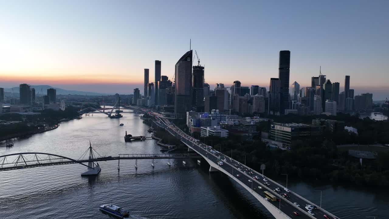 Panning aerial shot of Brisbane City's Goodwill Bridge and Captain Cook Bridge Expressway Pacific Motorway