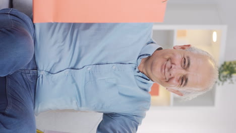 Vertical-video-of-Old-man-looking-at-camera-with-shopping-bags.