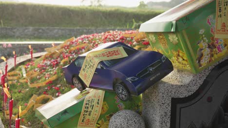 chinese ancestor honoring rituals with paper cars for qingming festival