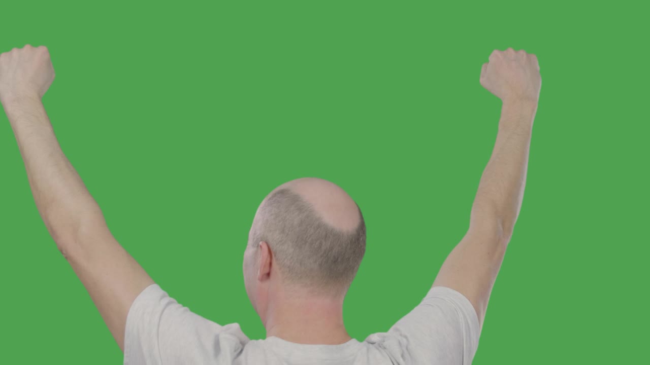 Man football fan raising hands up for celebrating goal while soccer match on green background. Success concept. Alpha channel, keyed green screen