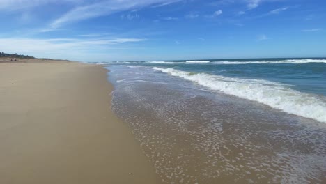 beautiful sunny day on a calm pristine beach with blue skies in north carolina in the outer banks in nags head during early summer