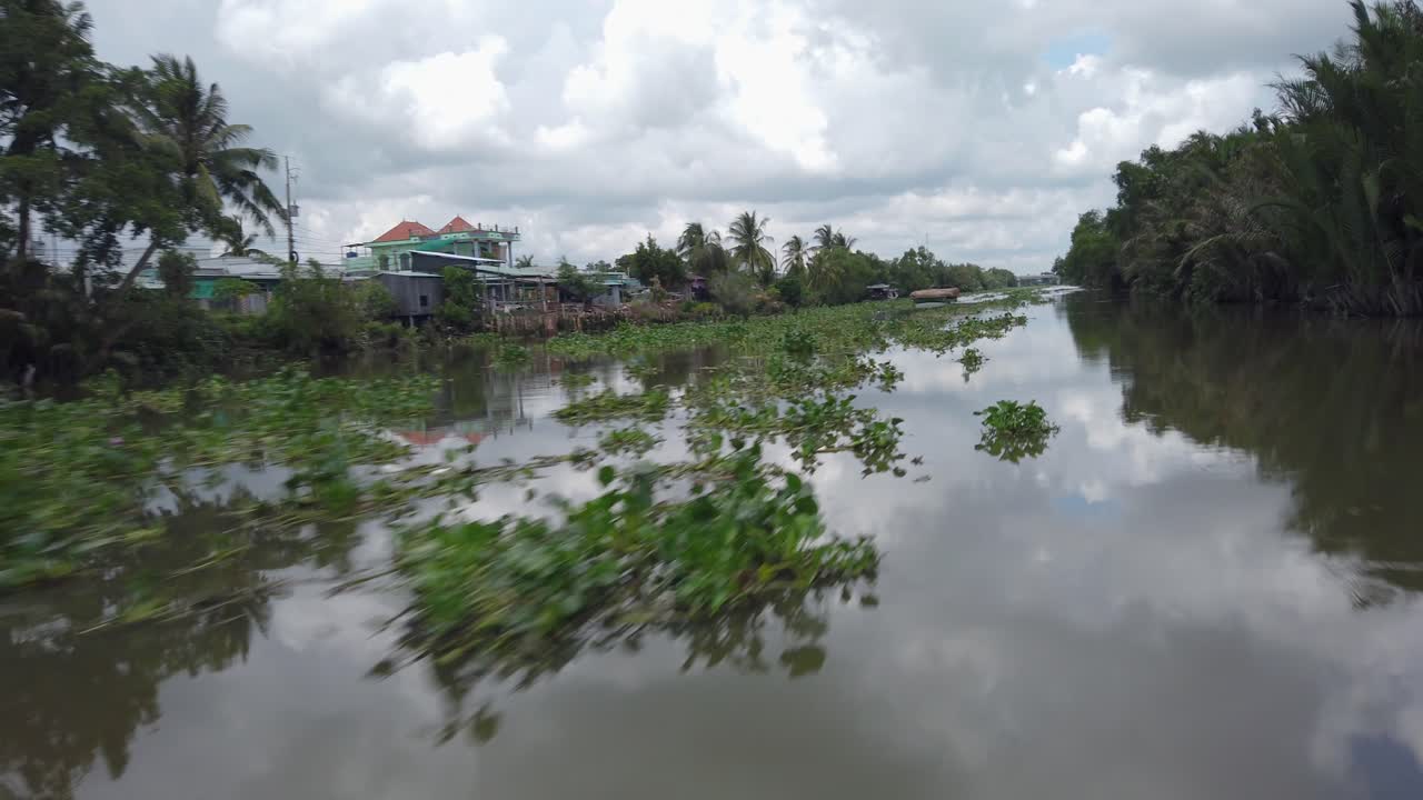A cargo boat navigating a river in the Mekong Delta, Vietnam