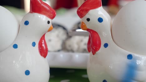decorated ceramic chicken eggcups with eggs